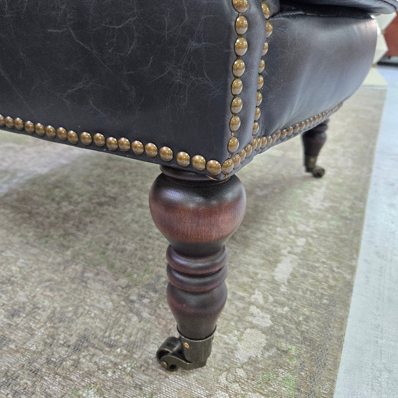 Black leather chair with brass studs