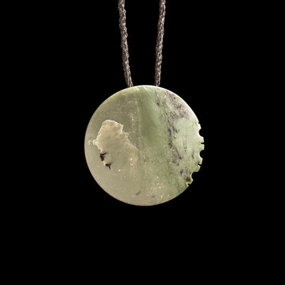 Jade disc pendant with korus by Madelyne Gourdin Necklace
